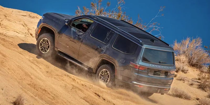 2024 Jeep Wagoneer Driving Up A Hill Offroad